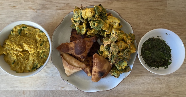 Homemade red lentil dhal, samosa, pakora, and coriander mint sauce